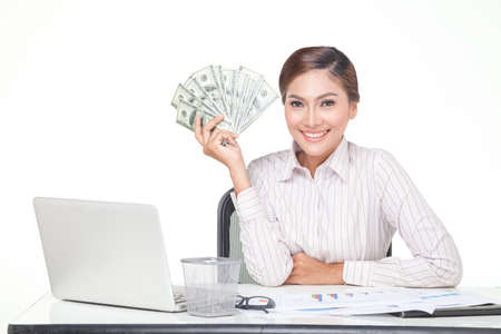 Asian business woman hold some of bank notes in hand with smiling face. isolated whiteの写真素材