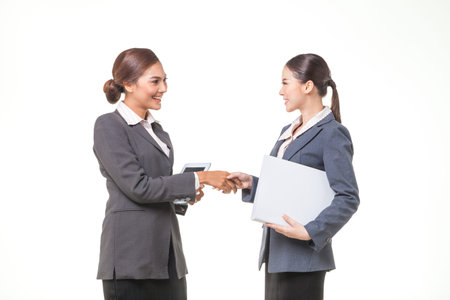 Two asian business women shake hand together on white background