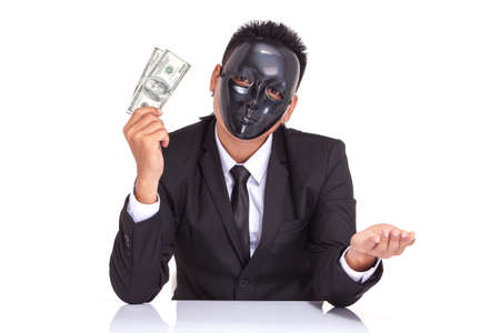 businessman with black glossy fancy mask holding bank noteの写真素材