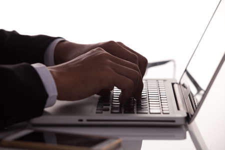 Silhouette hands on the laptop keyboardの写真素材