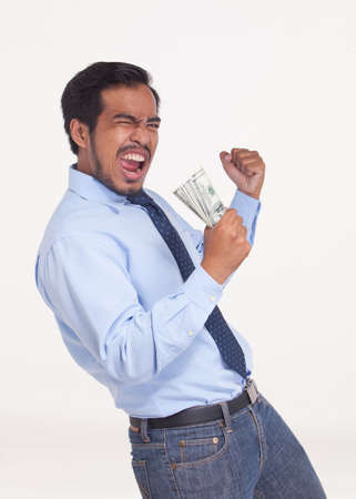 Portrait of asian business man enjoying success, get winning bonus money.の写真素材