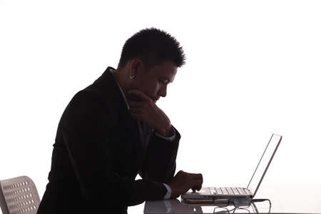 silhouette side view businessman use laptop computer on tableの写真素材