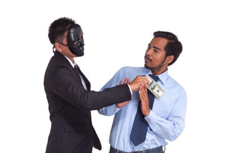 A man in suit put bank note in the pocket. Corruption.の写真素材