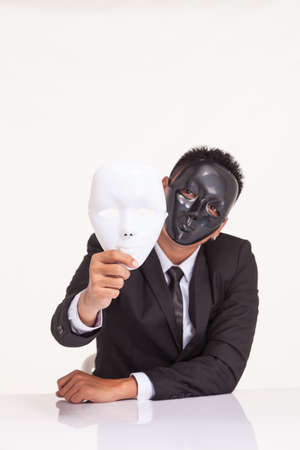 insincere espionage businessman swap the fancy maskの写真素材