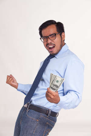 Portrait of asian business man enjoying success, get winning bonus money.の写真素材