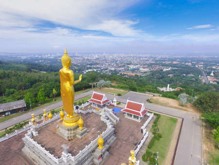 Big golden standing buddha statue on the hill top of Hat Yai, Songkhla, Thailandの写真素材