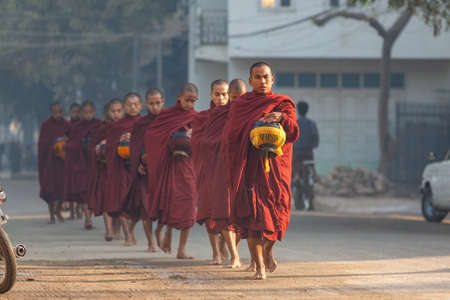 Bagan, Myanmar - January 25, 2009: Monks walking along the road in Bagan, Myanmar.のeditorial素材