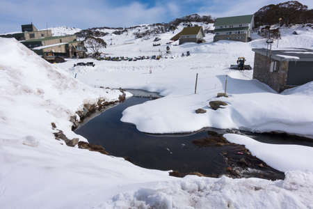 Small streams flow down the hill. Of snow covered peaksの写真素材