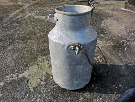 Rent to bring old milk can throw on the roof of the house.の写真素材