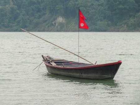 A boat on river with nepal flagの写真素材