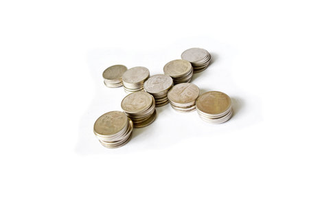 X or Wrong mark by rows of coins on white background,Business and financeの写真素材