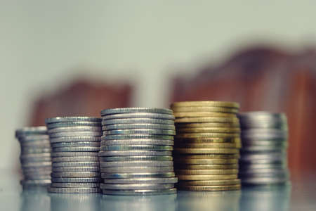Stacks coins row on a green marble slab, Silver and gold coin . Financial and commit business conceptの写真素材