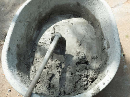 Using a hoe for concrete mixer, Bucket for mixing cement for construction work in Thailandの写真素材