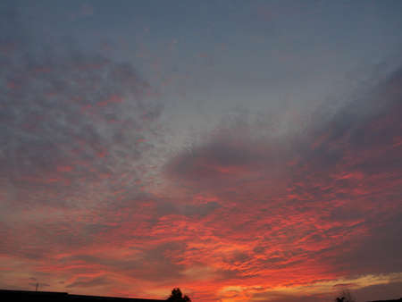 Dark cloud and blue sky in magic hour at sunset, The horizon began to turn orange with purple and pink cloud at night, Dramatic cloudscape areaの写真素材