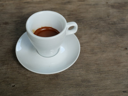 Espresso Coffee  in white cup on brown wooden table , Hot drink on ceramic plateの写真素材