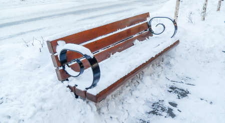 wooden bench on the snow, Hanging Chair in the park covered with snow, snow covered Hanging chairの写真素材