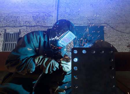 Industrial Worker at the factory welding closeupの写真素材