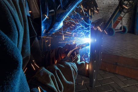 Industrial Worker at the factory welding closeup
