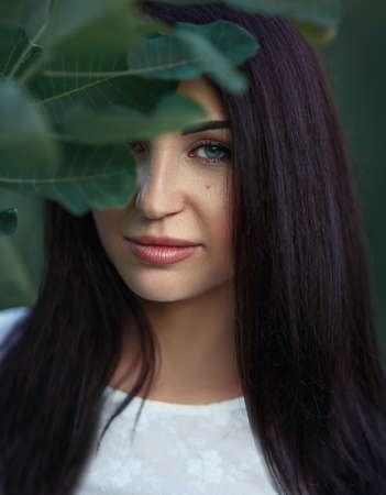 portrait of a beautiful girl in retro style in natureの写真素材