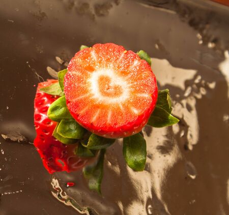 strawberry fruit cut in half with love heart silhouetteの写真素材