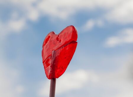 lollipop candy heart in blue sky and clouds backgroundの写真素材