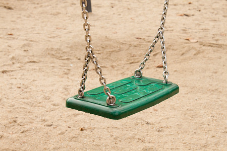 green swing isolated in the kids playgroundの写真素材