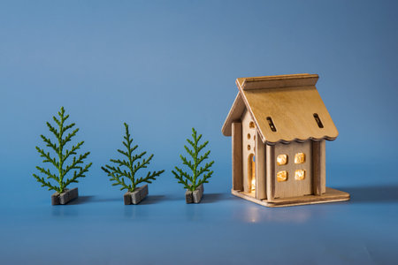 small homemade wooden house with a garland inside and a Christmas treeの写真素材