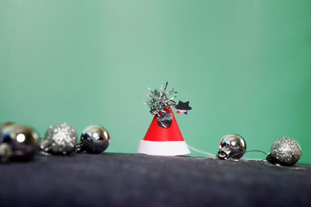 red carnival santa Claus hat with Christmas decorations and silver ballsの写真素材