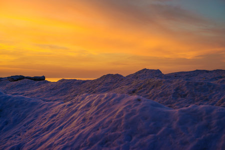 Blocks of ice on the seashore at sunsetの写真素材