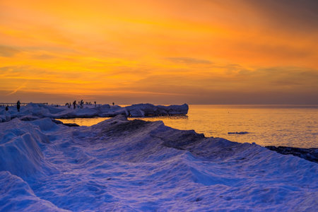 Blocks of ice on the seashore at sunsetの写真素材