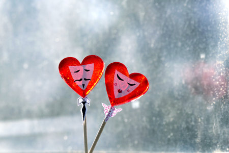Two red hearts on a stick on the background of the window.の写真素材