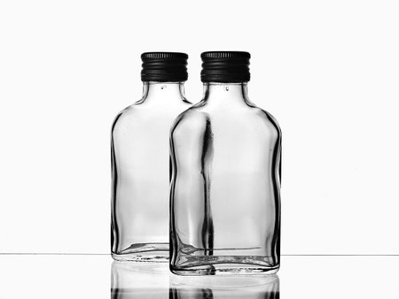 empty glass bottles isolated on a white background. black and white photoの写真素材