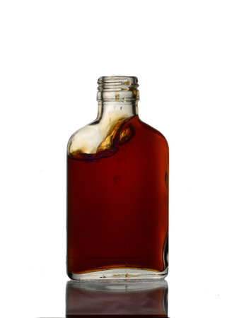 bottle of cognac on a white background with reflection and shadowの写真素材