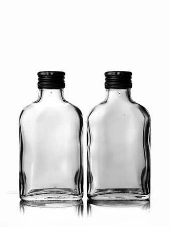 Two empty glass bottles isolated on white background. close-up.の写真素材