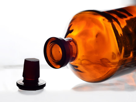 close up of a brown bottle on a white background with a black capの写真素材
