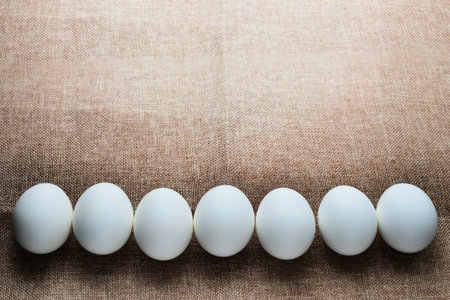 white eggs on sackcloth background with copy space for text or image