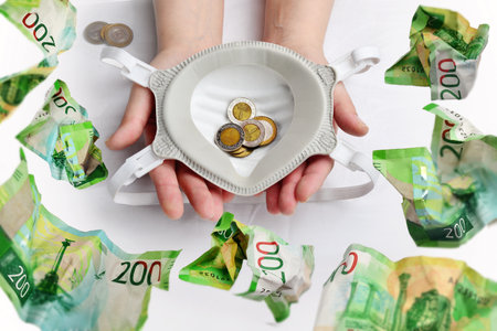 Hands of woman with euro banknotes and coins on white backgroundの写真素材