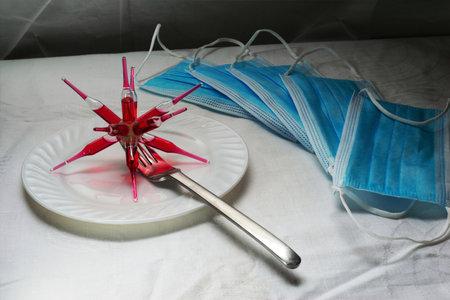 syringe with blood on a plate and medical mask, conceptual imageの写真素材