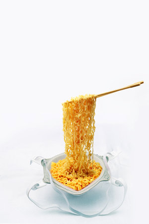 Instant noodles in a bowl on a white background. selective focus.の写真素材