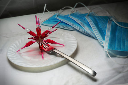 Surgical mask and syringe with blood on the table. Coronavirus concept.の写真素材