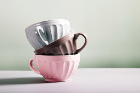 Cup of coffee or tea on the white table and green backgroundの写真素材