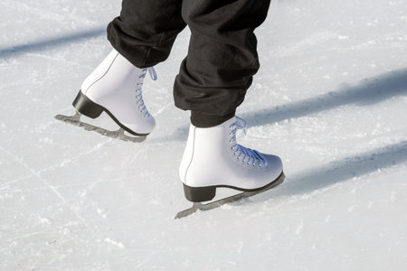 feet of a man skating on an ice rink, close-up