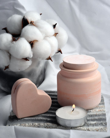 Spa still life with cotton flower, candle and soap on white backgroundの写真素材