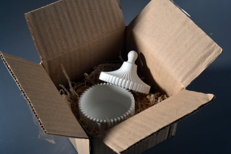 disposable plastic cup in a cardboard box on a black backgroundの写真素材