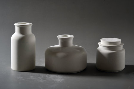 Three white plastic bottles on a gray background. Mock-up.の写真素材