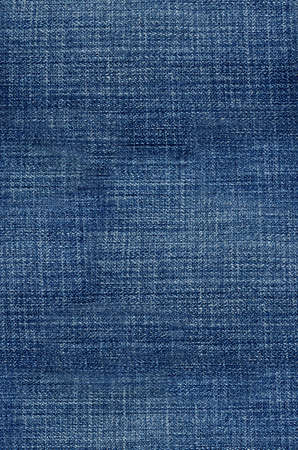 Seamless jeans texture. Perspective and closeup view to abstract space of empty light blue natural clean denim texture for the traditional business background in cold bright colors with diagonal shift tilt lines and stitchesの写真素材