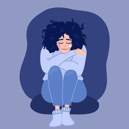 Illustration of depression in flat style. Sad girl with a tear hugs herself on a dark blue background.のイラスト素材