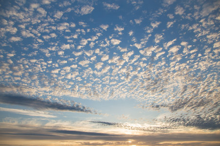 Beautiful blue sky at sunset with white cirrus, fluffy clouds. Sky panorama for screensavers,...