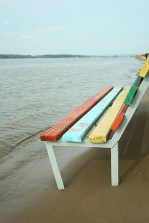 Colored bench on the beach on sunny dayの写真素材