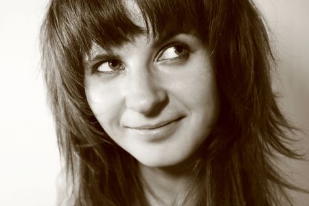 Young woman smiling while looking awayの写真素材